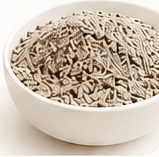Bentonite cat litter granules in a white bowl