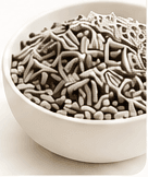 Mixed cat litter pellets in a white bowl