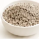 Bentonite cat litter granules in a white bowl